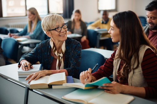 a retiree working with a student in a classroom