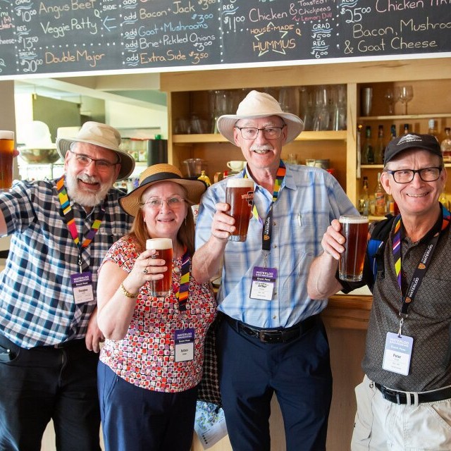 four retirees raising a toast to retirement well deserved