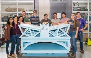 Students smiling, standing behind of a bridge mockup