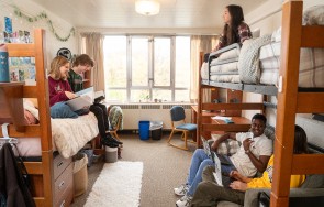 Students sitting on their bunk beds in Conrad Grebel residence, studying