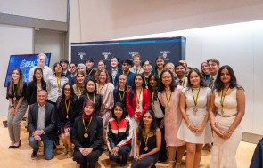 A number of students from the IDEAL Scholar Program standing and posing with their medals