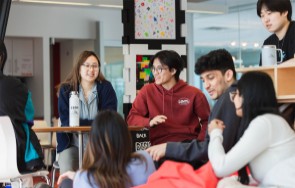 A number of students sitting and discussing information in Stratford